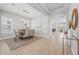 Spacious dining area with modern light fixture and wood floors; open to entry and living area at 12755 Westside Village Loop, Windermere, FL 34786