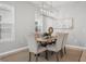 Dining area featuring stylish chairs, modern light fixture, and neutral decor at 12755 Westside Village Loop, Windermere, FL 34786