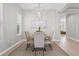 Elegant dining room with stylish chandelier and seating for four at 12755 Westside Village Loop, Windermere, FL 34786