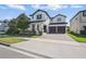 Beautiful two-story home featuring a two-car garage, well-manicured lawn, and tasteful landscaping at 12755 Westside Village Loop, Windermere, FL 34786
