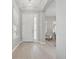 Bright foyer features elegant chandelier, wood floors, and views into the living area at 12755 Westside Village Loop, Windermere, FL 34786