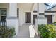 Inviting front entryway with decorative columns and wrought iron railing leading to a stylish door at 12755 Westside Village Loop, Windermere, FL 34786