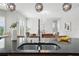 Stylish kitchen showcasing a sink and a view into the adjacent living room at 12755 Westside Village Loop, Windermere, FL 34786