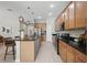 Open kitchen featuring an island with bar seating, stainless appliances, and modern pendant lighting at 12755 Westside Village Loop, Windermere, FL 34786