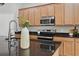 Modern kitchen featuring granite countertops, stainless steel appliances and light wood cabinets at 12755 Westside Village Loop, Windermere, FL 34786