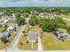An aerial view showing the home and neighborhood, nestled among lush greenery and nearby residences at 1422 Missouri Ave, St Cloud, FL 34769