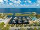 An aerial view of a marina with docks, boats, and a picturesque waterfront restaurant on a sunny day at 1422 Missouri Ave, St Cloud, FL 34769
