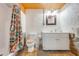 Bathroom with rustic interior design with textured walls, stone features, and shower with curtain at 1422 Missouri Ave, St Cloud, FL 34769