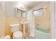 Bathroom features a bathtub with shower head and an above-counter sink with traditional tile and neutral color palette at 1422 Missouri Ave, St Cloud, FL 34769