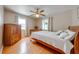 A bedroom featuring wood floors, two windows and a ceiling fan at 1422 Missouri Ave, St Cloud, FL 34769