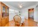 A dining room featuring wood floors, white walls, three windows and a ceiling fan at 1422 Missouri Ave, St Cloud, FL 34769