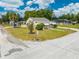 The home features a well-manicured lawn, mature landscaping, an attached carport and awning-covered windows at 1422 Missouri Ave, St Cloud, FL 34769