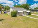 Charming single-story home featuring a well-manicured lawn, a quaint pathway, and stylish awning-covered windows at 1422 Missouri Ave, St Cloud, FL 34769