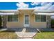 Charming home exterior featuring awnings and a decorative stone entryway at 1422 Missouri Ave, St Cloud, FL 34769