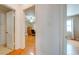 A hallway featuring wood floors and a view to an office at 1422 Missouri Ave, St Cloud, FL 34769