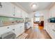 A kitchen featuring white cabinets, wood-look flooring, stainless steel appliances and a double sink at 1422 Missouri Ave, St Cloud, FL 34769