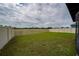 Large grassy backyard enclosed by a tall wooden privacy fence at 164 Emanuelle Dr, Winter Haven, FL 33884