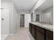 A bright bathroom with dual vanity sinks, large mirror and separate walk in shower at 164 Emanuelle Dr, Winter Haven, FL 33884
