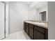 Bathroom vanity featuring double sinks, granite countertop, and tile flooring at 164 Emanuelle Dr, Winter Haven, FL 33884