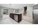 Open kitchen with an island, stainless steel appliances, and sliding glass doors at 164 Emanuelle Dr, Winter Haven, FL 33884
