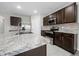 Spacious kitchen with stainless appliances, granite countertops, and dark cabinets at 164 Emanuelle Dr, Winter Haven, FL 33884