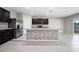 Open kitchen with granite counters, stainless appliances, and center island at 164 Emanuelle Dr, Winter Haven, FL 33884