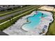 Aerial view of the community pool featuring a modern design and lots of lounge chairs at 164 Emanuelle Dr, Winter Haven, FL 33884
