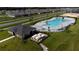 Aerial view of the community pool with an irregular shape and ample seating around it at 164 Emanuelle Dr, Winter Haven, FL 33884