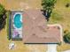 Aerial view of the home featuring a screened-in pool, mature landscaping, and backyard patio at 1941 Mathis Rd, St Cloud, FL 34771