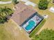 High angle aerial view of home featuring screened-in pool, backyard patio, and lush landscaping at 1941 Mathis Rd, St Cloud, FL 34771