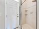 Tiled walk-in shower with glass door and door to outside at 1941 Mathis Rd, St Cloud, FL 34771
