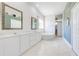 Bathroom with dual sinks, tub, and tile flooring, bright with natural light at 1941 Mathis Rd, St Cloud, FL 34771