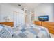 Comfortable bedroom with tiled flooring, ceiling fan, and view into bathroom at 1941 Mathis Rd, St Cloud, FL 34771