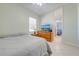 Bright bedroom with tiled floor, ceiling fan and view into the adjoining room at 1941 Mathis Rd, St Cloud, FL 34771