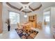 Dining room boasts an elegant ceiling design, wooden furniture, and a large window that fills the space with natural light at 1941 Mathis Rd, St Cloud, FL 34771