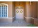 Grand double front doors with decorative wreaths, tile flooring, and a transom window create an elegant entry at 1941 Mathis Rd, St Cloud, FL 34771
