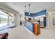 Bright kitchen with stainless steel appliances, granite countertops, and an open view to the pool area at 1941 Mathis Rd, St Cloud, FL 34771