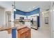 Modern kitchen with a stainless steel refrigerator, granite countertops, and ample cabinet space at 1941 Mathis Rd, St Cloud, FL 34771