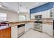 Updated kitchen showcasing stainless steel appliances, granite counters and a seamless flow to the living area at 1941 Mathis Rd, St Cloud, FL 34771