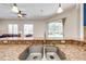 Granite countertop and stainless steel sink in the kitchen, offering a view of the living room and pool area at 1941 Mathis Rd, St Cloud, FL 34771