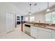 Open kitchen design with stainless appliances, granite counters, and tile flooring adjacent to the living room and fireplace at 1941 Mathis Rd, St Cloud, FL 34771