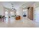 Spacious living room with neutral tile flooring, ceiling fan, and sliding glass doors to the lanai at 1941 Mathis Rd, St Cloud, FL 34771