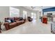 Open concept living room with tile flooring seamlessly connecting to the kitchen area at 1941 Mathis Rd, St Cloud, FL 34771