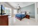 Main bedroom with a sliding glass door to a patio, ceiling fan, and tile floor at 1941 Mathis Rd, St Cloud, FL 34771