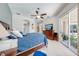 Main bedroom with sliding door access to the lanai, and a ceiling fan at 1941 Mathis Rd, St Cloud, FL 34771