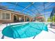 Gorgeous screened-in pool area with lounge seating and lush landscaping offers the perfect outdoor escape at 1941 Mathis Rd, St Cloud, FL 34771