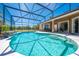 Inviting pool with clear, sparkling water inside screened enclosure at 1941 Mathis Rd, St Cloud, FL 34771