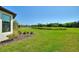 Expansive backyard with a lush lawn and peaceful pond views, providing a serene outdoor space at 1948 Molise Dr, Kissimmee, FL 34759