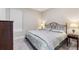 Cozy bedroom with an iron bed frame, two side tables, and a patterned duvet cover at 1948 Molise Dr, Kissimmee, FL 34759