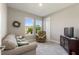 Cozy bedroom featuring a large window, a sofa, and a TV at 1948 Molise Dr, Kissimmee, FL 34759